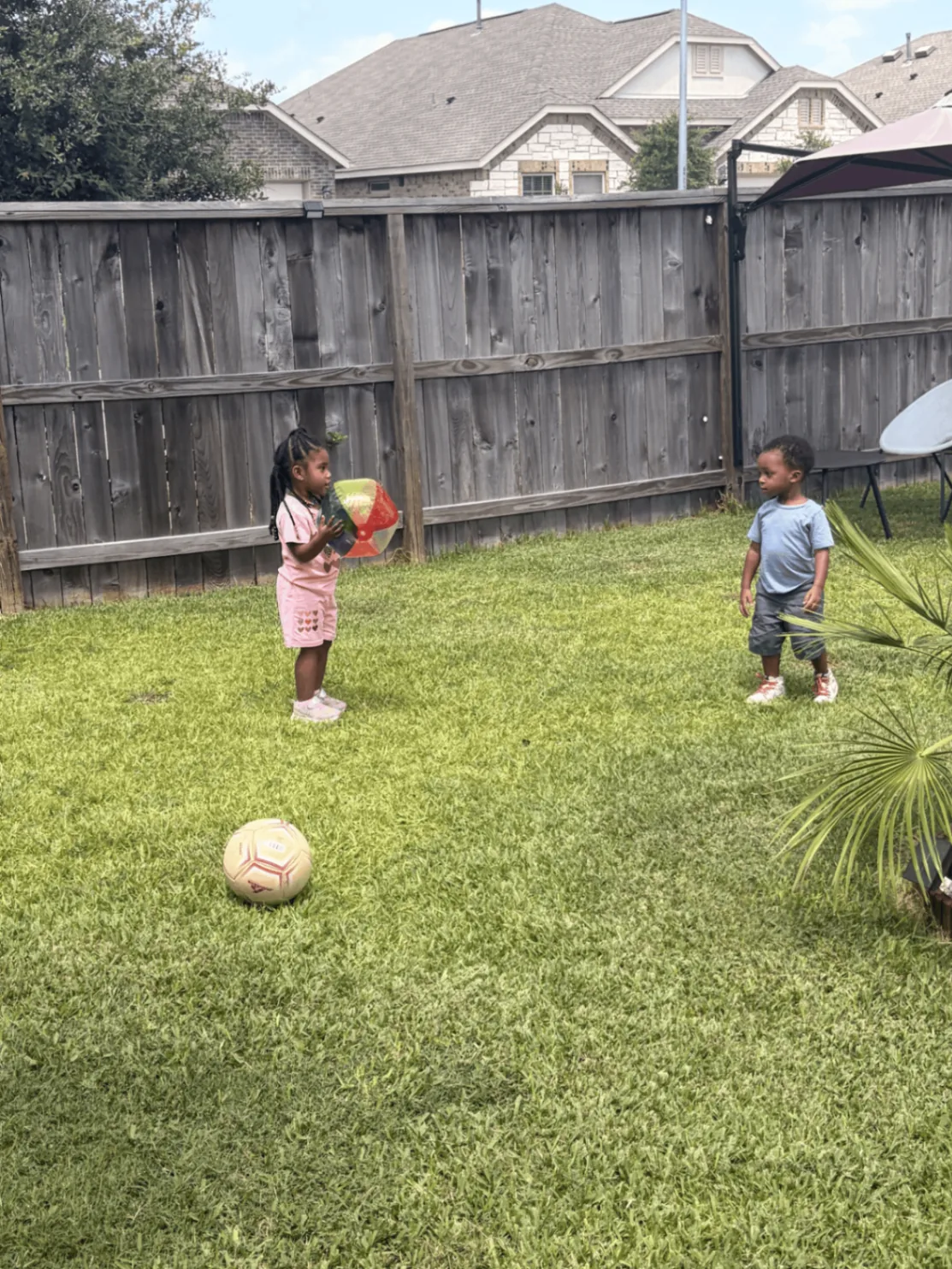 Preschool children counting and playing with balls outdoors