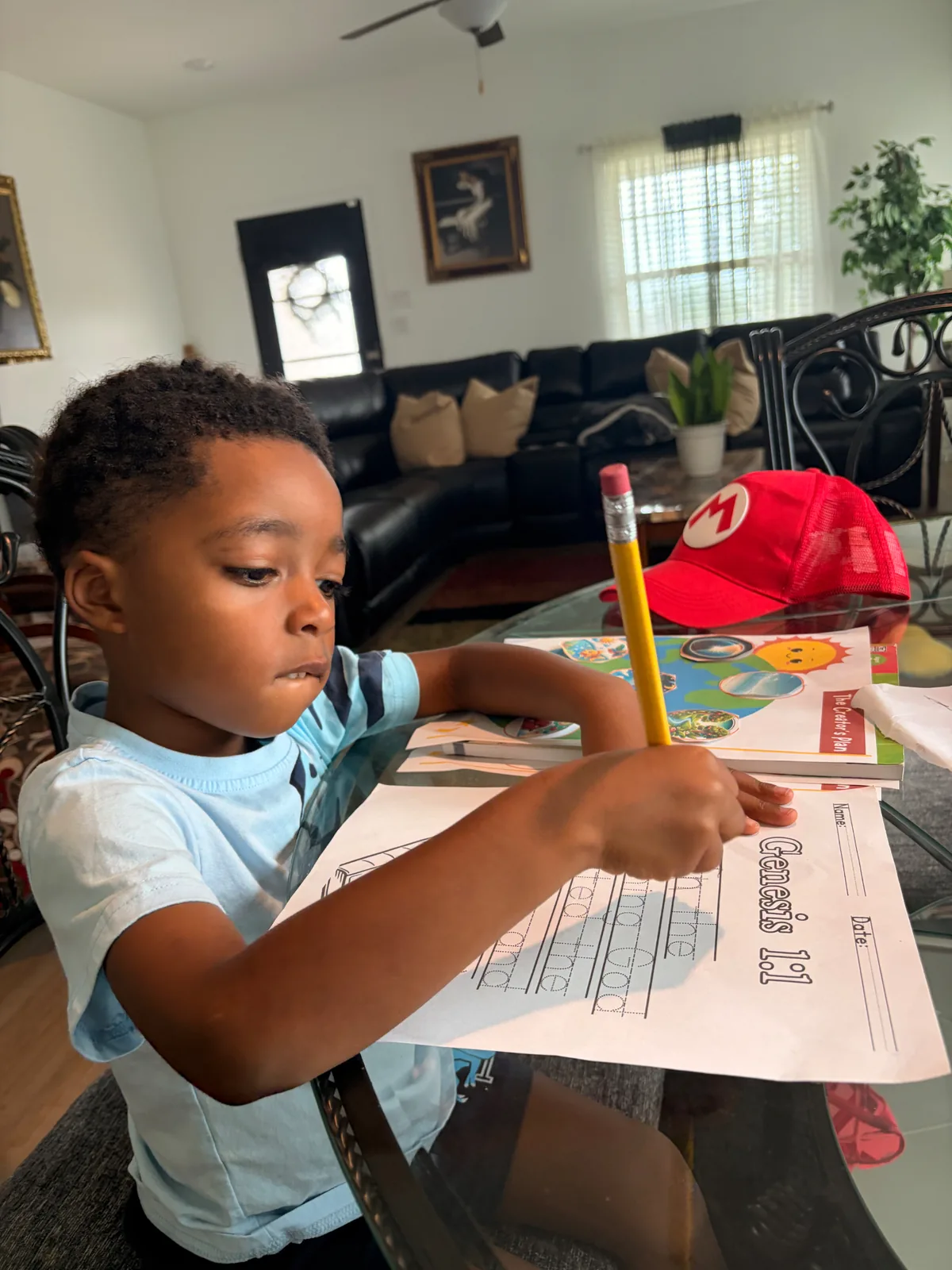 Preschool child writing Genesis 1:1 to build biblical literacy skills