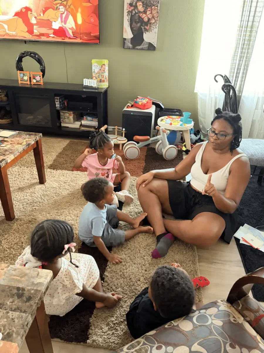 Preschool children sitting together on a circle time rug building confidence and belonging