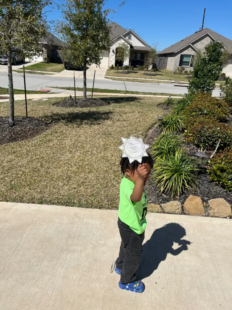 Preschool child proudly showing a colorful craft project